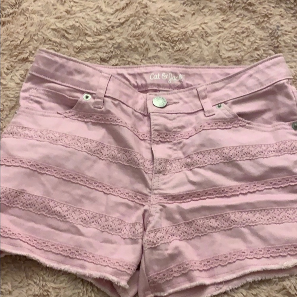 purple jean shorts with design going across.